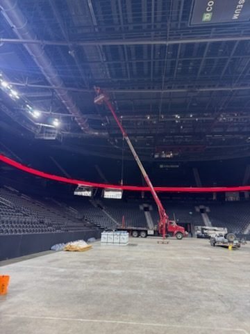 Sentry boom truck working inside arena