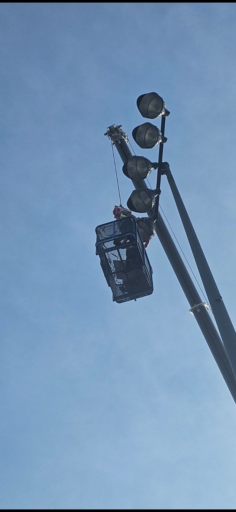 Worker in basket at light heads