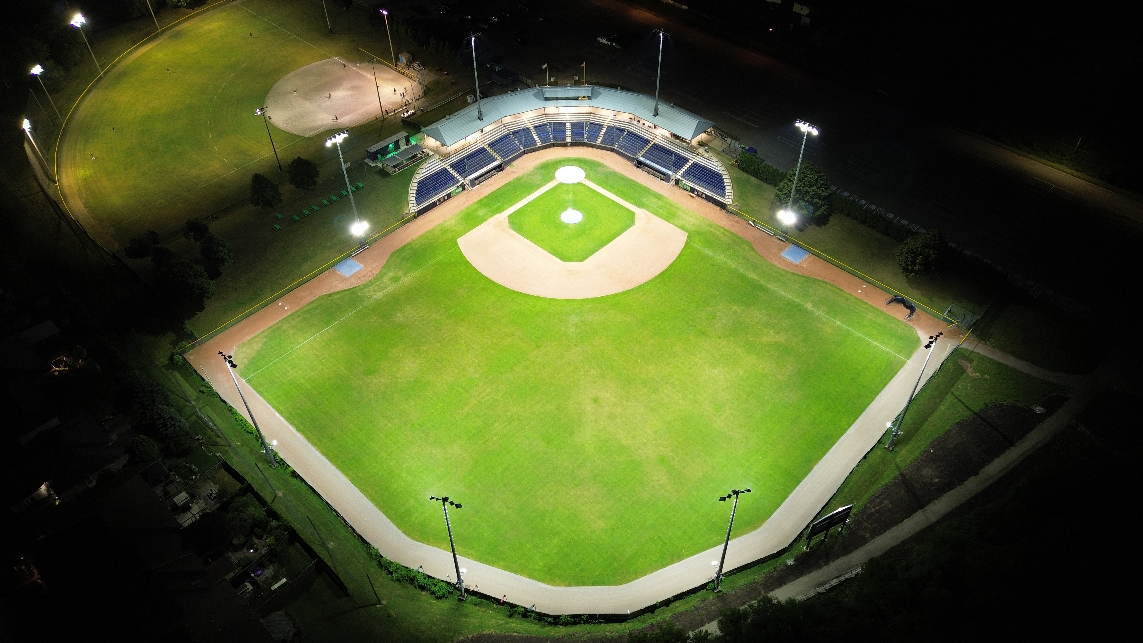 Field of play under white game lights from outfield